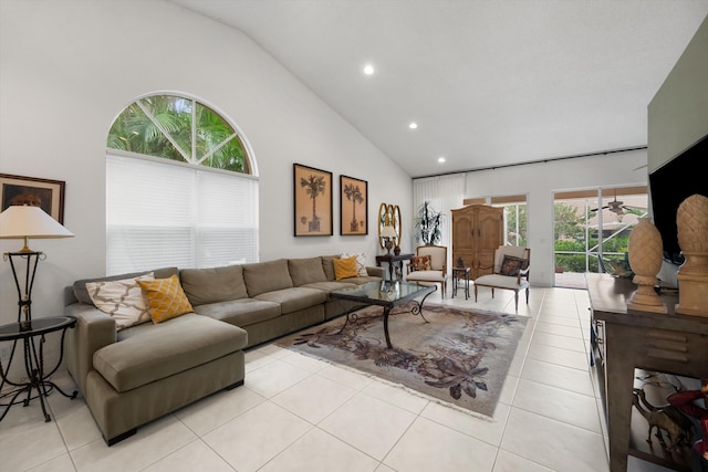 living room featuring a wealth of natural light, light tile patterned floors, and high vaulted ceiling