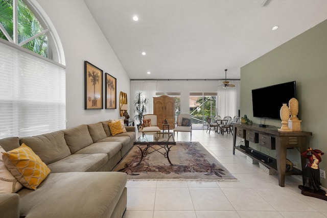 tiled living room featuring ceiling fan and lofted ceiling