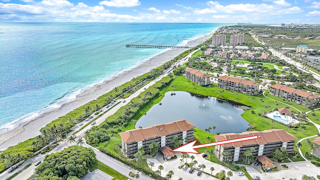 birds eye view of property with a water view and a view of the beach