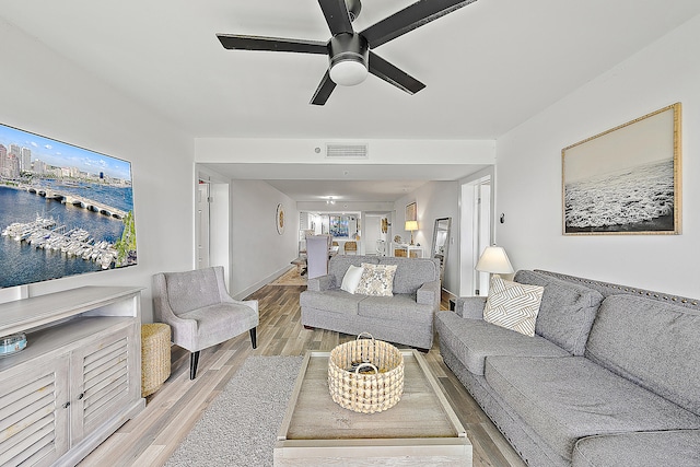 living room with light hardwood / wood-style floors and ceiling fan