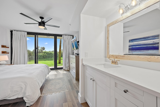 bedroom with sink, ceiling fan, light hardwood / wood-style flooring, and access to exterior