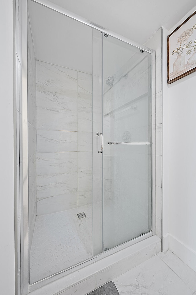 bathroom with a shower with shower door