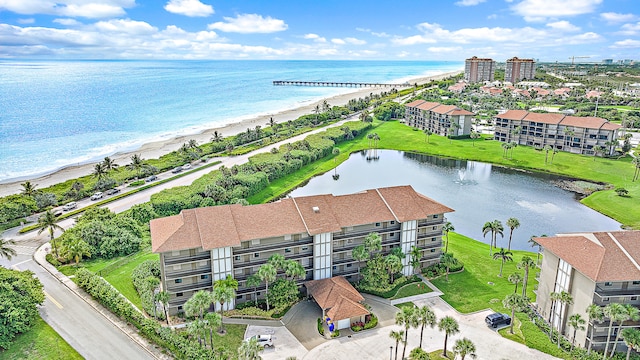 drone / aerial view featuring a water view and a beach view