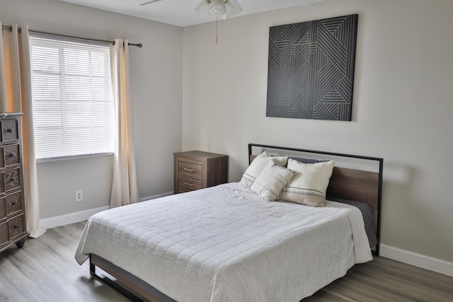 bedroom with ceiling fan and wood-type flooring