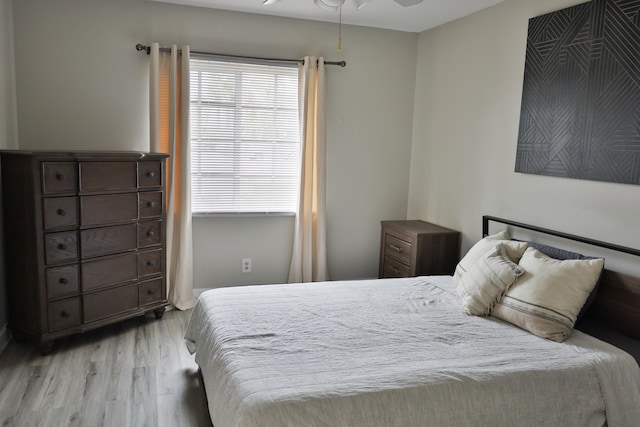 bedroom with light hardwood / wood-style floors and ceiling fan