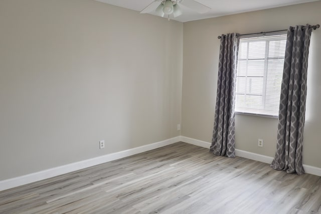 empty room with ceiling fan and light hardwood / wood-style flooring