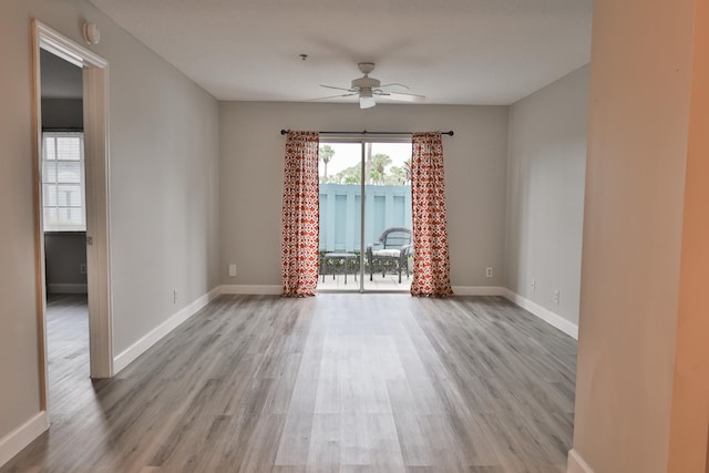 empty room with ceiling fan and light wood-type flooring