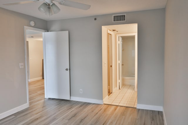 unfurnished bedroom featuring ceiling fan, light hardwood / wood-style flooring, and ensuite bathroom