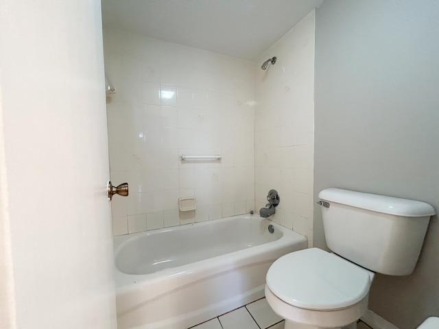 bathroom with tiled shower / bath combo, toilet, and tile patterned flooring