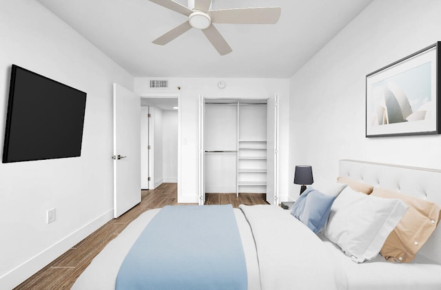 bedroom featuring hardwood / wood-style floors, a closet, and ceiling fan