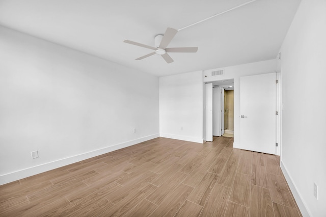 spare room featuring light hardwood / wood-style flooring and ceiling fan