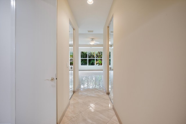 hallway featuring light tile patterned floors