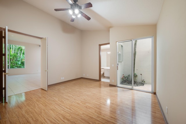 unfurnished room with light hardwood / wood-style floors, vaulted ceiling, and ceiling fan