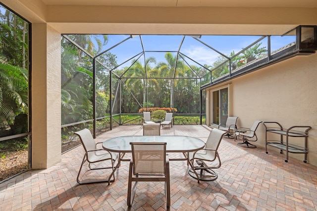 view of patio featuring a lanai