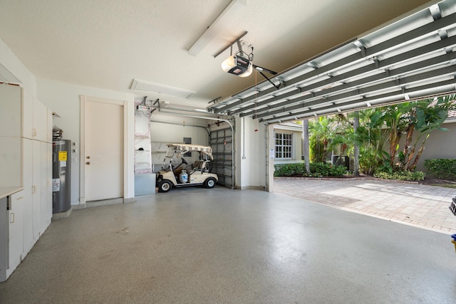 garage featuring water heater and a garage door opener