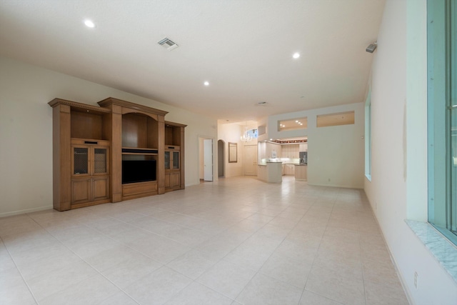 unfurnished living room with light tile patterned flooring