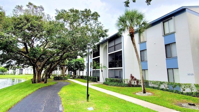 view of home's community featuring a yard and a water view