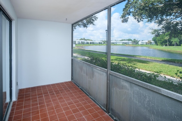 unfurnished sunroom featuring a wealth of natural light and a water view