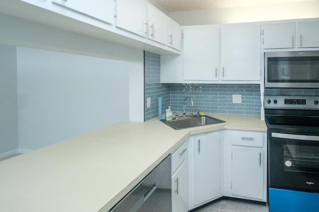 kitchen featuring sink, dishwashing machine, backsplash, white cabinetry, and electric stove