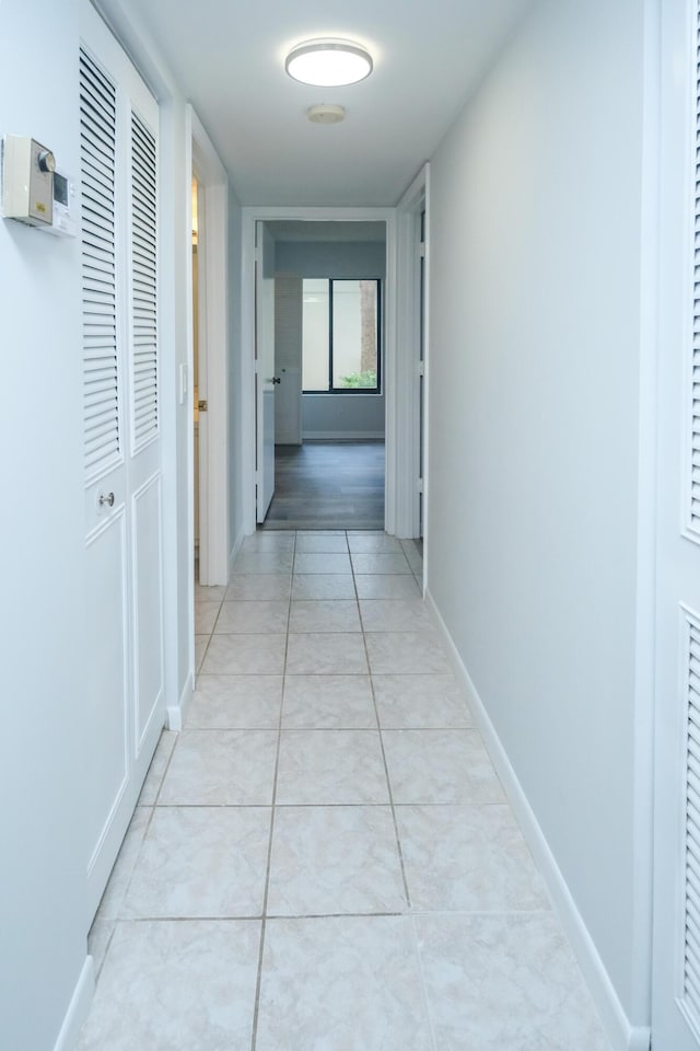 hall with light tile patterned floors