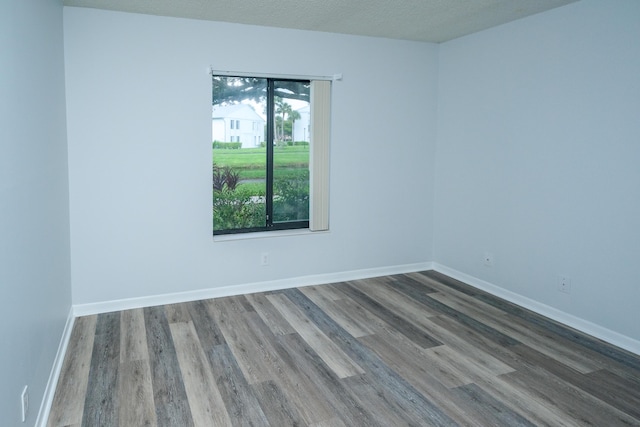 spare room with hardwood / wood-style flooring and a healthy amount of sunlight