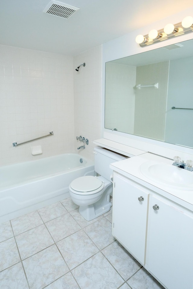 full bathroom featuring toilet, tiled shower / bath, tile patterned floors, and vanity