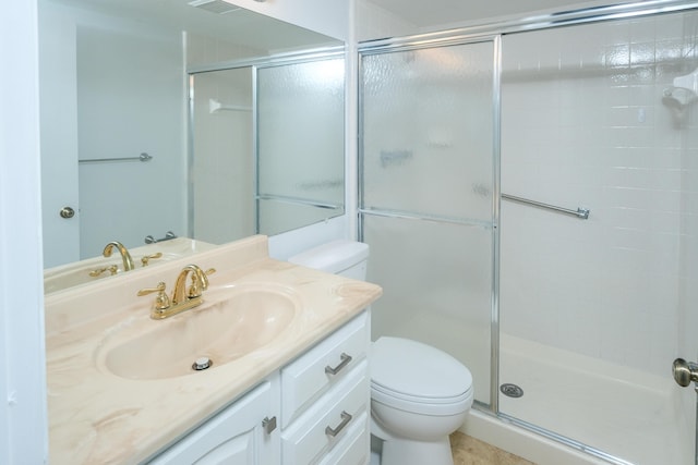 bathroom with vanity, toilet, and a shower with door