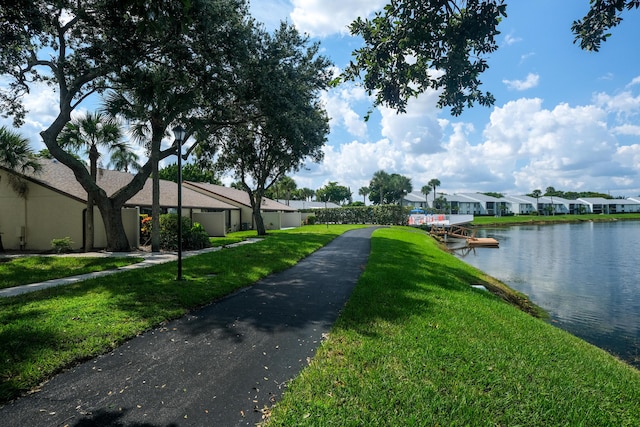 exterior space featuring a yard and a water view