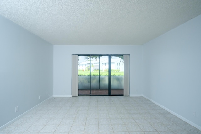 spare room with a textured ceiling