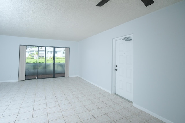 unfurnished room with ceiling fan and a textured ceiling