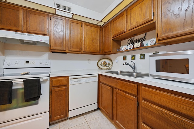 kitchen featuring white appliances, light countertops, a sink, and under cabinet range hood