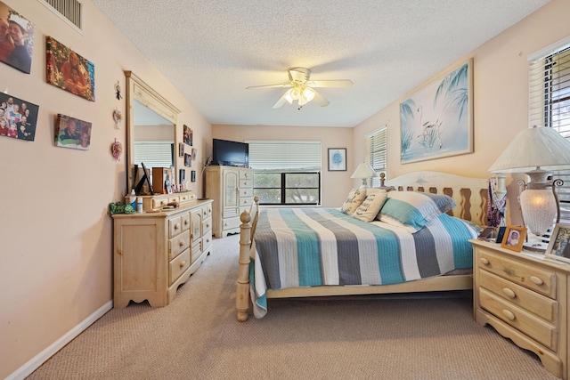 9780 Pineapple Tree Dr Unit 201, Boynton Beach, FL 33436 - bedroom featuring light carpet, multiple windows, a textured ceiling, a ceiling fan, and baseboards