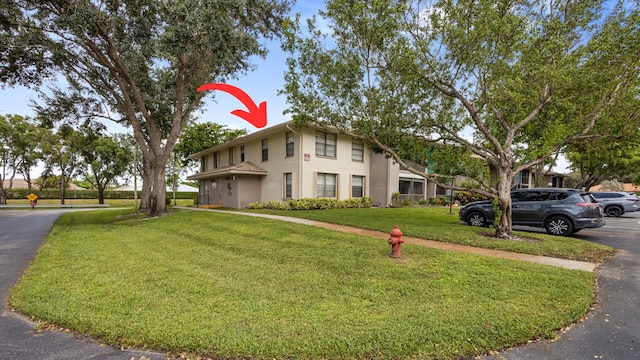 view of front of property with a front lawn and stucco siding