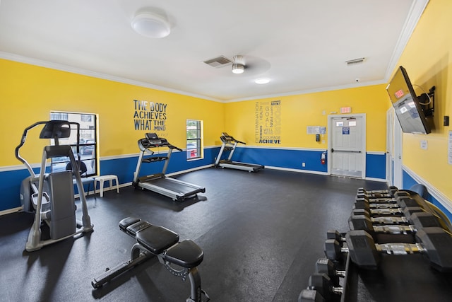 gym featuring a ceiling fan, visible vents, crown molding, and baseboards