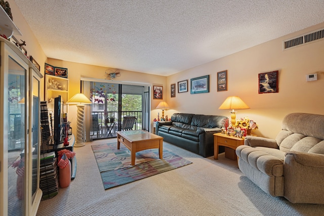 living area with carpet, visible vents, and a textured ceiling