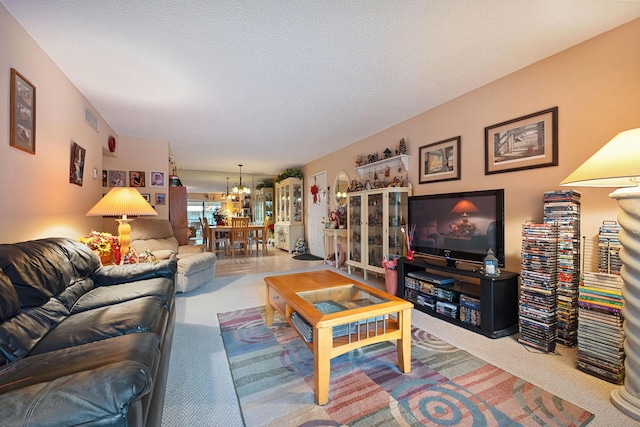 9780 Pineapple Tree Dr Unit 201, Boynton Beach, FL 33436 - living area with a chandelier, carpet floors, and a textured ceiling