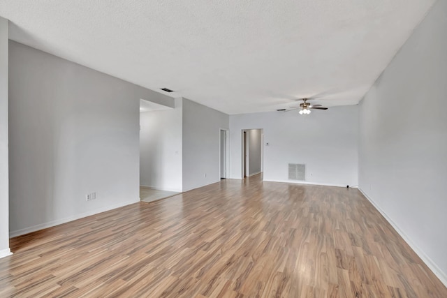 unfurnished room with light hardwood / wood-style flooring, a textured ceiling, and ceiling fan