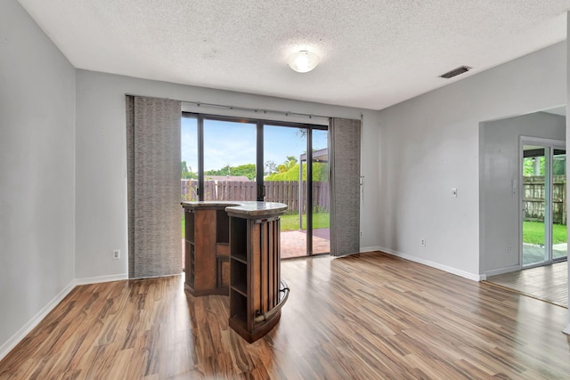 living room with hardwood / wood-style floors and a textured ceiling