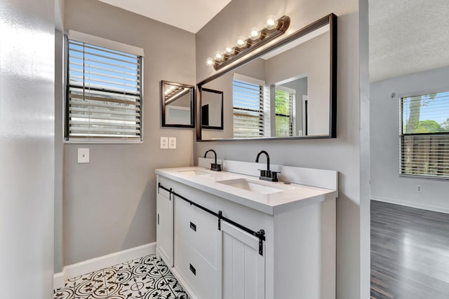 bathroom with vanity, a textured ceiling, and hardwood / wood-style floors