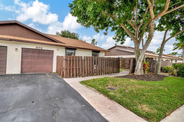 exterior space with a yard and a garage