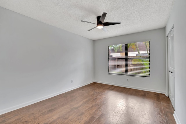 spare room featuring a textured ceiling, dark hardwood / wood-style floors, and ceiling fan