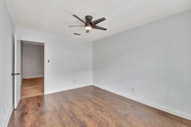 unfurnished room with dark hardwood / wood-style floors, a textured ceiling, and ceiling fan