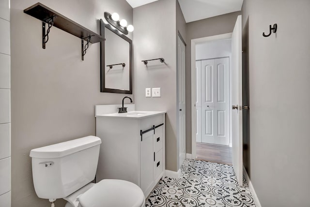 bathroom with vanity, toilet, and wood-type flooring