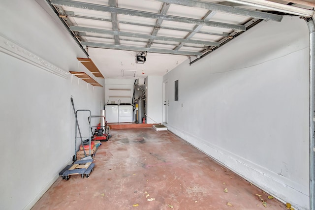 garage featuring a garage door opener, electric water heater, electric panel, and separate washer and dryer