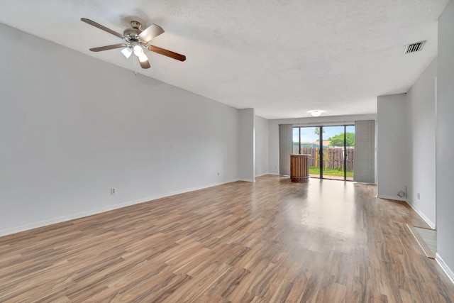 unfurnished room featuring a textured ceiling, wood-type flooring, and ceiling fan