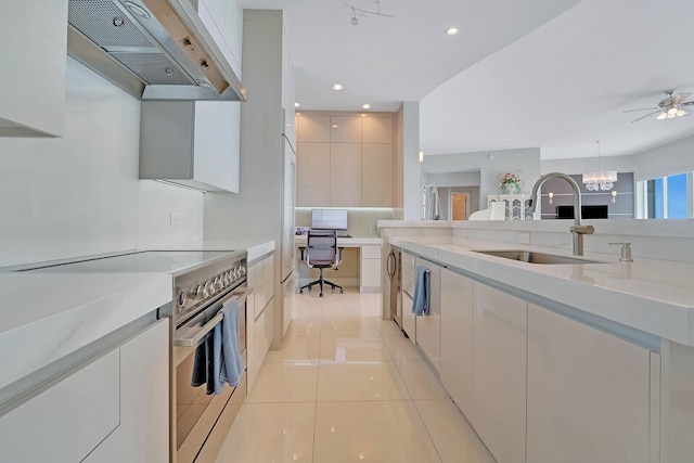 kitchen featuring stainless steel range with electric cooktop, white cabinets, wall chimney range hood, sink, and light tile patterned floors