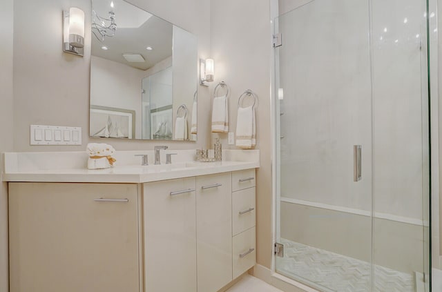 bathroom featuring vanity and an enclosed shower