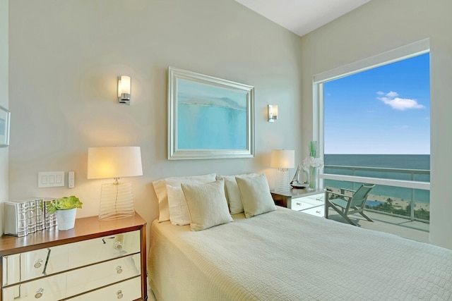 bedroom with a water view and hardwood / wood-style flooring