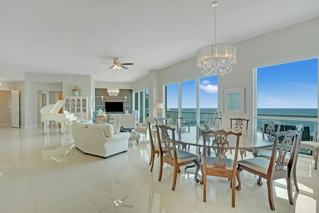 dining room featuring ceiling fan with notable chandelier and light tile patterned floors