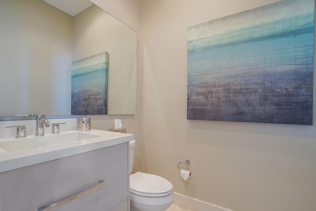 bathroom featuring tile patterned flooring, vanity, and toilet